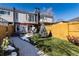 Fenced backyard with a patio area, a red umbrella, and a walkway at 14 N Jackson St, Denver, CO 80206