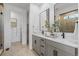 Elegant dual vanity bathroom with a walk-in tiled shower and modern fixtures at 16514 W 93Rd Way, Arvada, CO 80007