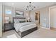 Modern bedroom with stylish wallpaper, a comfortable bed, and an attached bathroom at 16514 W 93Rd Way, Arvada, CO 80007