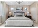 Cozy bedroom featuring a plush bed, modern accents, and soft carpeting at 16514 W 93Rd Way, Arvada, CO 80007