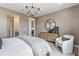 Spacious bedroom with a comfortable bed, stylish furniture, and access to the bathroom and kitchen at 16514 W 93Rd Way, Arvada, CO 80007