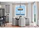 Dining area with round table, modern chandelier, large windows, and city views at 16514 W 93Rd Way, Arvada, CO 80007