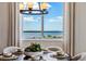 Large windows framing a picturesque view of a city skyline from a dining area at 16514 W 93Rd Way, Arvada, CO 80007