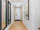 Welcoming entryway with wood floors, a white door, and stylish mirrors at 16514 W 93Rd Way, Arvada, CO 80007