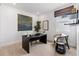 Functional and stylish home office with a black desk, chair, and artwork at 16514 W 93Rd Way, Arvada, CO 80007