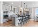 Modern kitchen featuring gray cabinets, stainless steel appliances, and an island with bar seating at 16514 W 93Rd Way, Arvada, CO 80007