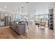 Open-concept kitchen and living area with gray cabinets, an island, and hardwood floors at 16514 W 93Rd Way, Arvada, CO 80007