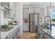 Modern kitchen with stainless steel appliances, gray shaker cabinets, and dark countertops at 16514 W 93Rd Way, Arvada, CO 80007