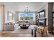 Inviting living room featuring a fireplace, large windows, and stylish furniture at 16514 W 93Rd Way, Arvada, CO 80007