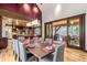 Open concept dining area with modern wood table and view of the backyard at 1003 Boreas Pass Rd, Breckenridge, CO 80424