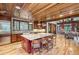 Open kitchen with large island, hardwood floors, and wood ceilings at 1003 Boreas Pass Rd, Breckenridge, CO 80424