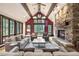 Living room features a stone fireplace, vaulted ceilings and large windows at 1003 Boreas Pass Rd, Breckenridge, CO 80424