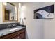 Stylish bathroom with dark vanity and large mirror at 1003 Boreas Pass Rd, Breckenridge, CO 80424