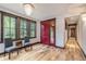 Bright entryway with hardwood floors, red door, and two gray chairs at 1003 Boreas Pass Rd, Breckenridge, CO 80424