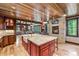 Island kitchen with breakfast bar and a stone fireplace at 1003 Boreas Pass Rd, Breckenridge, CO 80424
