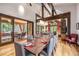 Elegant dining room with a large wooden table and access to a patio at 1003 Boreas Pass Rd, Breckenridge, CO 80424