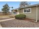 Tan siding townhouse exterior with a white door and small landscaping at 5711 W 92Nd Ave # 15, Westminster, CO 80031