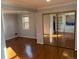 Bedroom with hardwood floors, large closet, and access to other rooms at 6150 E Kentucky Ave, Denver, CO 80224