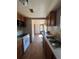 Kitchen with white appliances, wood cabinets, and a double sink at 2080 Emporia St, Aurora, CO 80010