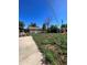 Backyard with a large grassy area and a paved driveway at 2080 Emporia St, Aurora, CO 80010