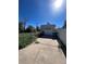 Detached garage with a paved driveway and green trash bin at 2080 Emporia St, Aurora, CO 80010