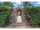 Stone arch pathway leading to a tranquil backyard oasis at 740 12Th St, Boulder, CO 80302