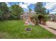 Landscaped backyard with patio, stone arbor, and mature trees at 740 12Th St, Boulder, CO 80302