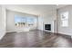 Bright living room with a fireplace and large windows offering plenty of natural light at 1785 Marlowe E Cir, Erie, CO 80516