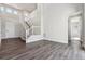 Living area with wood floors and a staircase leading to the second story at 1785 Marlowe E Cir, Erie, CO 80516