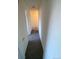 Simple hallway with carpeted floors and neutral colored walls at 8031 Wolff St # H, Westminster, CO 80031