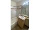 Clean bathroom with bathtub, sink, and light colored tile at 8031 Wolff St # H, Westminster, CO 80031