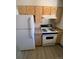 Kitchen with light wood cabinets and white appliances at 8031 Wolff St # H, Westminster, CO 80031