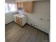 Kitchen features light wood cabinets and a white sink at 8031 Wolff St # H, Westminster, CO 80031