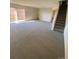 Spacious living room with neutral carpeting and sliding glass door at 8031 Wolff St # H, Westminster, CO 80031