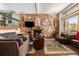 Living room with wood-paneled wall, fireplace and comfortable seating at 505 Village Rd # 42, Breckenridge, CO 80424