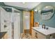 Basement bathroom with walk-in shower, updated vanity, and stylish mirror at 115 Spruce Rd, Golden, CO 80401