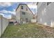 Fenced backyard with grass, a small tree, and a playset at 18561 E 53Rd Ave, Denver, CO 80249