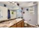 Clean bathroom with light-colored vanity and space-themed decor at 18561 E 53Rd Ave, Denver, CO 80249