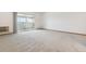 Spacious living area with sliding glass doors leading to a balcony at 610 S Alton Way # 8D, Denver, CO 80247