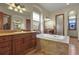 Luxurious bathroom with soaking tub, double vanity, and tile flooring at 6297 Ellingwood Point Way, Castle Rock, CO 80108