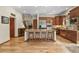 Bright kitchen boasts hardwood floors, granite island, and stainless steel appliances at 6297 Ellingwood Point Way, Castle Rock, CO 80108
