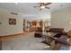 Open Gathering room with kitchen views, leather sofas, and hardwood floors at 6297 Ellingwood Point Way, Castle Rock, CO 80108