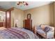 Spacious bedroom with dresser and comfy seating at 6297 Ellingwood Point Way, Castle Rock, CO 80108