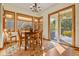 Bright breakfast nook with wood table and chairs, and access to a patio at 6297 Ellingwood Point Way, Castle Rock, CO 80108