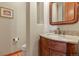 Elegant bathroom with a vanity, toilet and hardwood floors at 6297 Ellingwood Point Way, Castle Rock, CO 80108