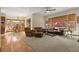 Gathering room with hardwood floors, leather furniture, and access to the kitchen at 6297 Ellingwood Point Way, Castle Rock, CO 80108