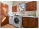 Convenient laundry room with washer, dryer, and cabinets at 6297 Ellingwood Point Way, Castle Rock, CO 80108