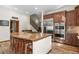 Gourmet kitchen with granite island, stainless steel appliances, and custom cabinetry at 6297 Ellingwood Point Way, Castle Rock, CO 80108
