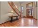 Elegant entryway with hardwood floors, curved staircase, and large windows at 6297 Ellingwood Point Way, Castle Rock, CO 80108