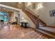 Grand entryway with hardwood floors and staircase at 6297 Ellingwood Point Way, Castle Rock, CO 80108